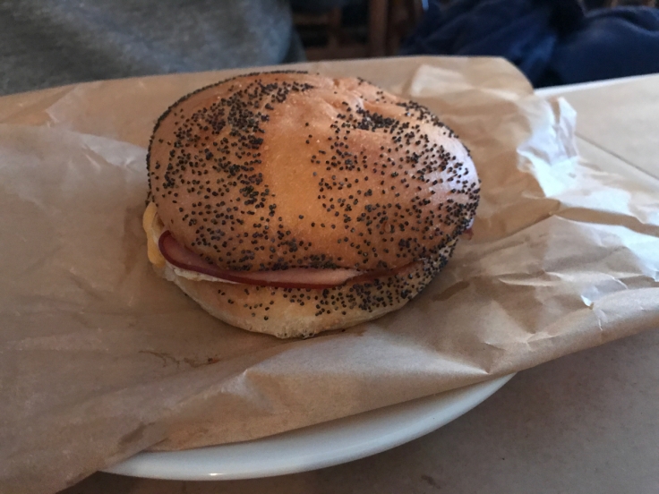 A photo of the L.I.E. Long Island egg sandwich at Diane's Bloody Mary in San Francisco, California. The sandwich consists of a pan fried organic egg, thinly sliced country ham and American cheese on a kaiser roll.