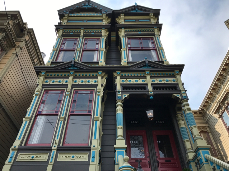 A stunning Victorian painted home on McAllister Street in San Francisco, California. This one features stained glass windows and gorgeous hues of blue, teal, red, burgundy, black, navy, pink, yellow and gold.