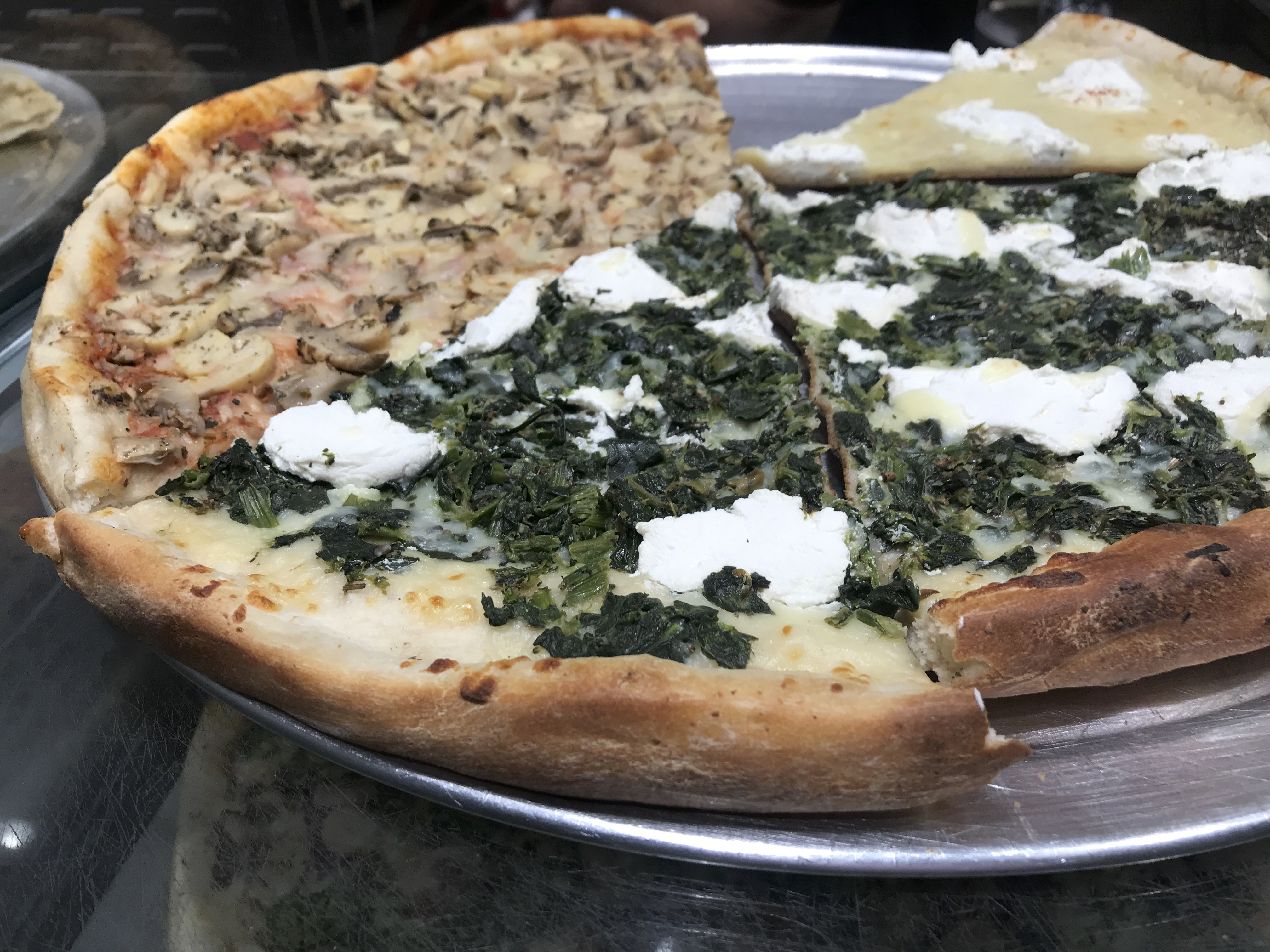 I’d Rather Be Eating a Slice - A photo of slices of ricotta and spinach at 2 Bros. Pizza restaurant in New York City, New York. Photo Courtesy of FoodWaterShoes